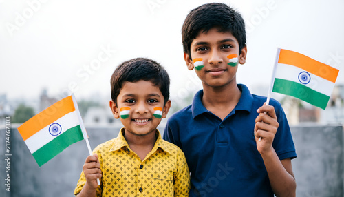 Happy Indian brothers celebrating Independence Day outdoor. Patriotic Indian children celebrating national festival on rooftop. 