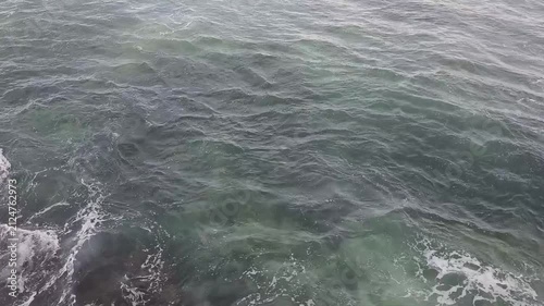 Calm waves at a beach with blue water