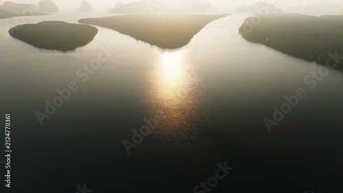 Colorful sunset or sunrise above the sea surface,Aerial view drone fly over open sea,Reflected sun beautiful light of nature on water surface,Sunset over ocean,Sea summer and travel vacation concept