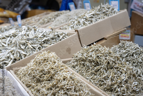 Принти на полотні Assorted dried anchovies displayed in cardboard trays at traditional Korean street market