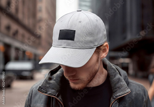 Man in the street wearing a blank cap with embroidered patch Mockup. Generative ai