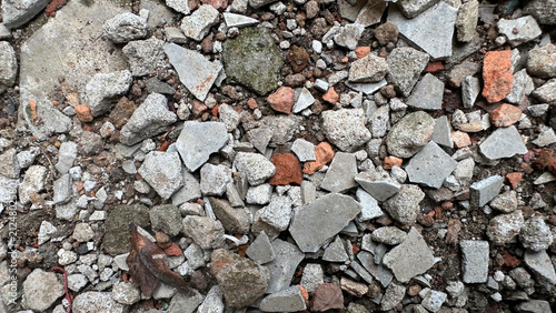 Scattered concrete rubble, broken bricks, and gravel fragments
