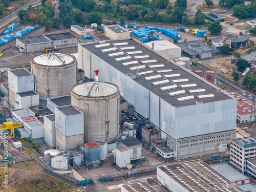 Aerial view of the Fessenheim Nuclear Power Plant with its distinctive reactor containment buildings, large industrial structures, and surrounding infrastructure in Fessenheim, Grand Est, France.