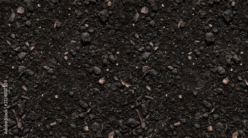 Close-up view of dark asphalt road surface with small stones and gravel.