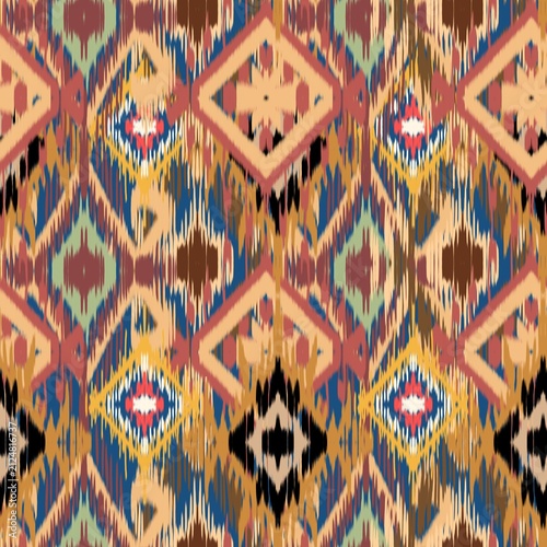 A vibrant modern Ikat bohemian seamless pattern featuring overlapping geometric diamond and zigzag shapes. The design stands out with its distinct fuzzy, brush-stroke edges that mimic traditional hand