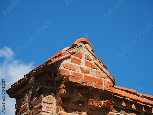 A triangular roof against a blue sky