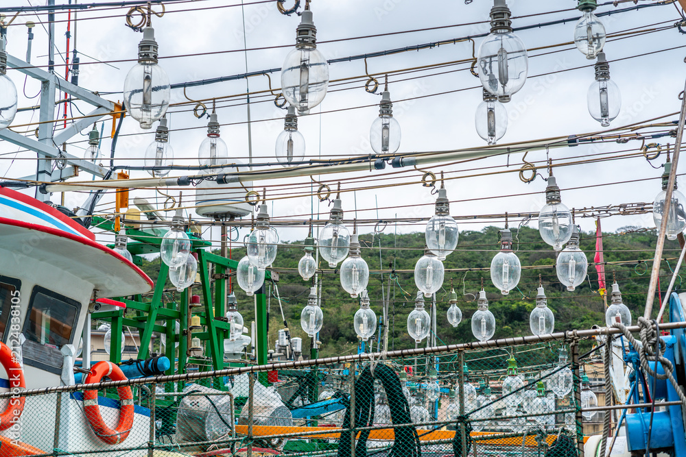 Fototapeta premium Close-up view of fishing boats equipped with fishing light attractor using light bulbs to attract fish in Taiwan
