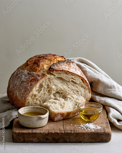 Artisan sourdough bread with olive oil sea salt and wooden board showcasing wabi sabi luxury food styling