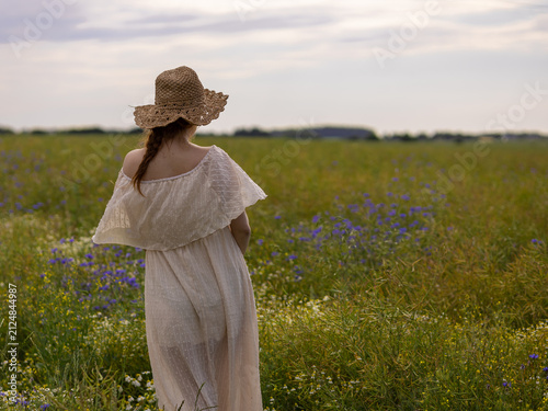 Quadro su tela Woman Seen from Behind Standing Alone in a Summer Wildflower Field