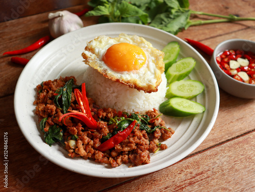 Stir-fried minced pork with Thai basil and a fried egg on rice. Pad kra pao authentic Thai food.