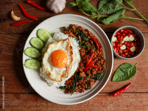 Stir-fried minced pork with Thai basil and a fried egg on rice. Pad kra pao authentic Thai food.