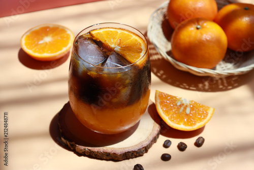 Iced orange americano with fresh orange sliced. Refreshing drinks for summer.