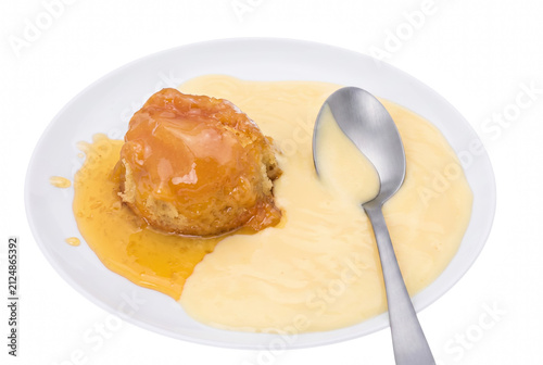 Obraz na płótnie Traditional Steamed Treacle Sponge Pudding Served with Creamy Custard on a White