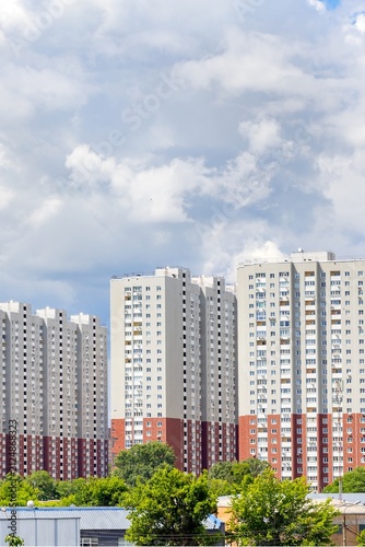 Tall buildings in city under cloudy sky in afternoon