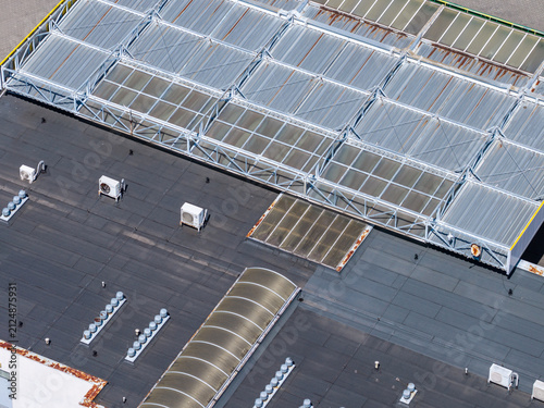 Принти на полотні Industrial building rooftop aerial view showing air conditioning units and skyli