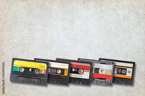 five audio cassettes on grunge background