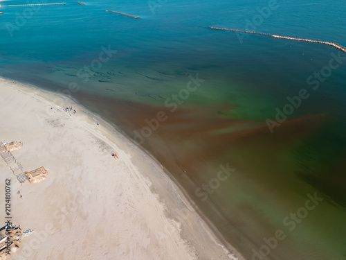 Картината върху платно High angle drone shot showing Mamaia beach resort, Black Sea coastline, beach hotels, Planetarium, and Tabacariei Lake under a clear blue sky in Constanta, Romania