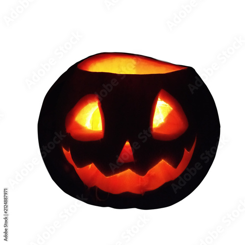 A dark-colored Halloween pumpkin with bright yellow illuminated eyes and a smile, isolated on a transparent background.