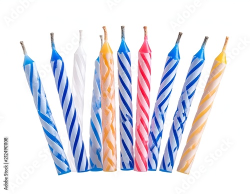Close-up of colorful swirled spiral birthday candles against a plain white background