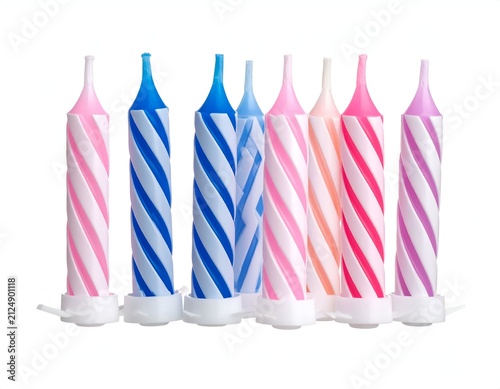A row of colorful spiral-striped birthday candles with white holders