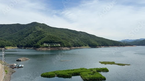 Soyang River Multipurpose Dam in Chuncheon, South Korea, under a clear blue sky. Beautiful landscape and mountain