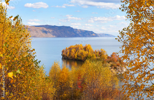 Autumn landscape of Lake Baikal. View of natural landmark and place of attraction for tourists - Cape Shamansky on September sunny windy day. Nature background. Outdoor activities, hiking and travel