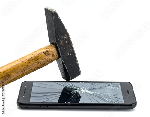 A hammer smashes a black smartphone, cracking the screen against a white background