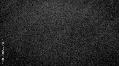 Abstract dark grainy texture background with subtle vignette effect