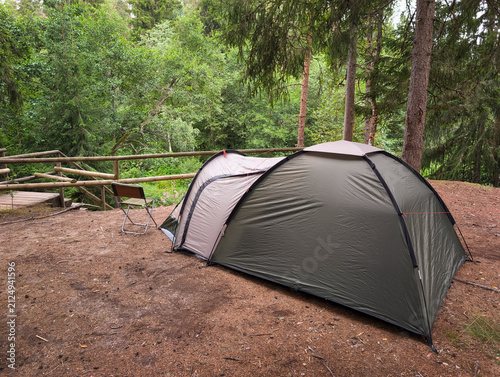 Tourist camping tent pitched at a public campsite surrounded by pine trees near Nommeveski in Lahemaa National Park Estonia.