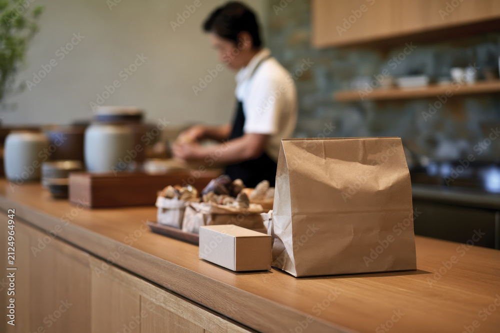 Fototapeta premium A charming bakery workspace captures the essence of creativity, showcasing neatly arranged baked goods with attention to detail and a warm atmosphere that encourages artisan practice.