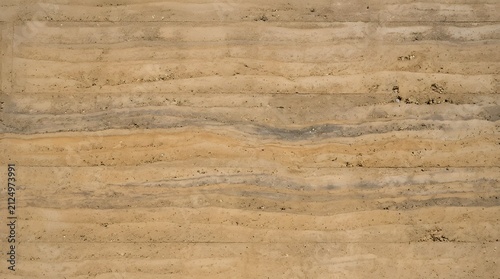 Textured rammed earth wall showing horizontal layers of compressed sand, soil, and clay with natural rustic organic aesthetic on transparent background
