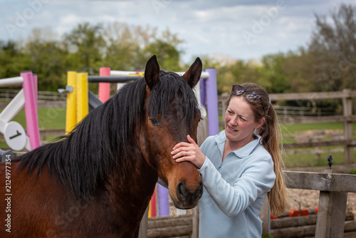 Woman Embracing a Bay Connemara Pony in an Outdoor Arena