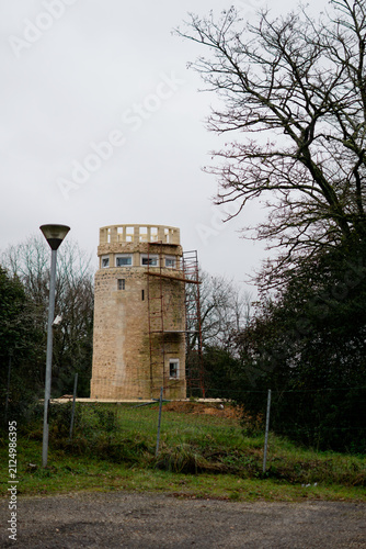 Stone Observation Tower Under Renovation on a Hillside in Lansac, France