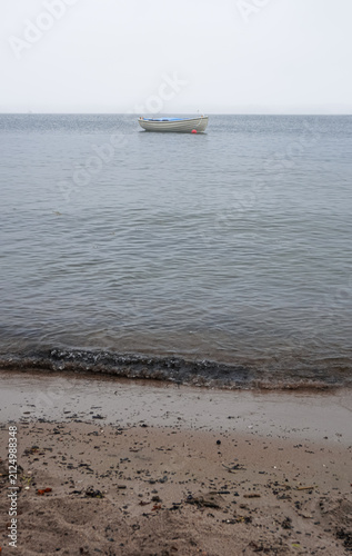 Small boat anchored near the shore
