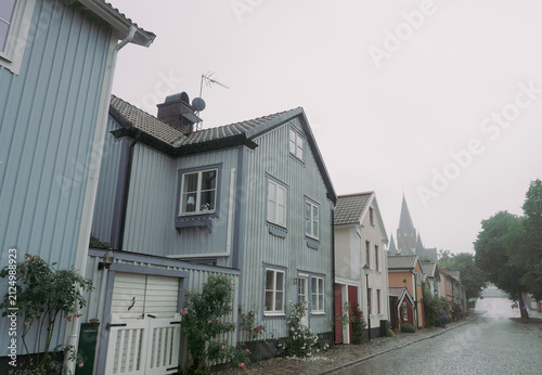 Wooden houses on rainy street