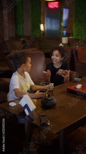 Black brother and sister drinking tea together