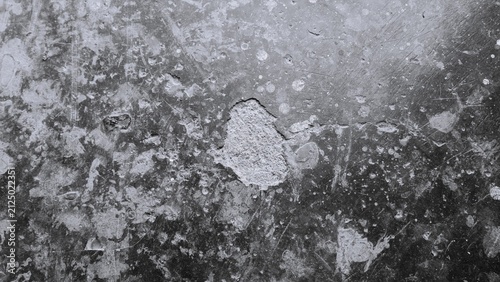 Obraz na plátně Weathered concrete surface in black and white with pitted texture, cracks, and rustic details