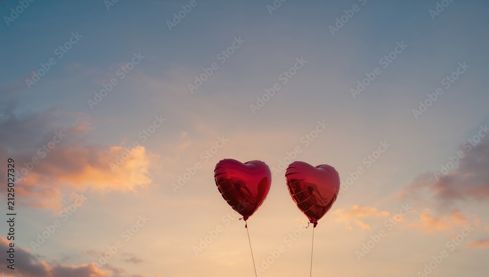 Obraz premium Heart-Shaped Balloons Floating in the Sky at Sunset