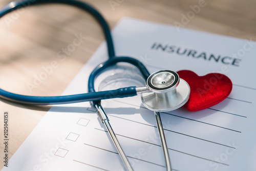 Health insurance concept. Stethoscope and red heart on insurance form represent medical coverage, policy, protection, healthcare, claim, security