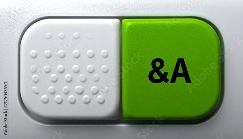 Close‑up of keyboard key divided into two sections, left side white with small raised dots, right side bright green with black text “&A,” visually symbolizing stylized or custom key design, possibly r