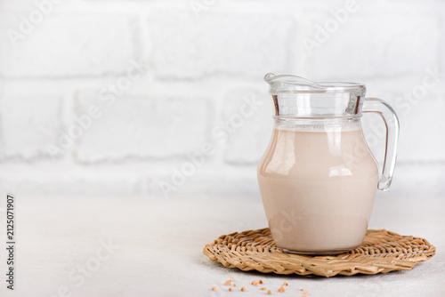 Natural homemade buckwheat milk with organic green buckwheat, vegan dairy alternative. Copy space.