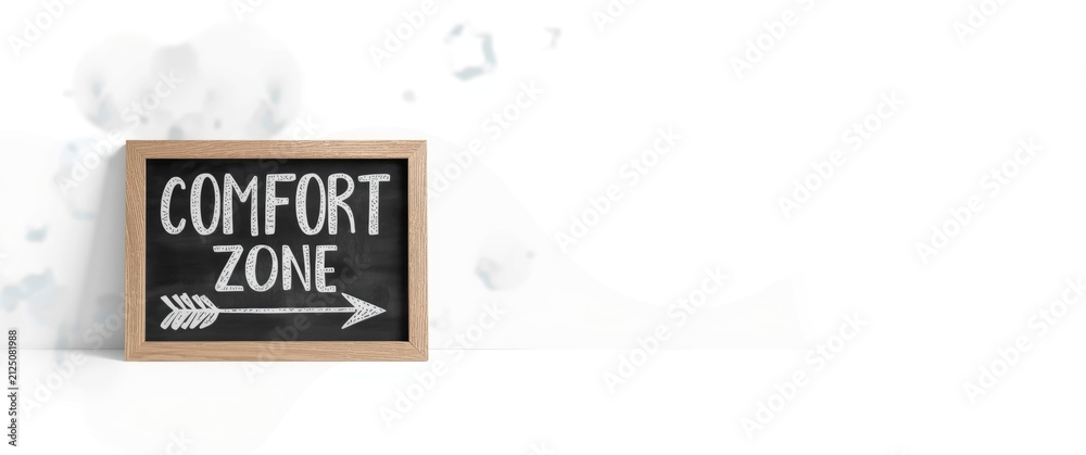 Naklejka premium Chalkboard Sign Reading Comfort Zone with Arrow on White Background
