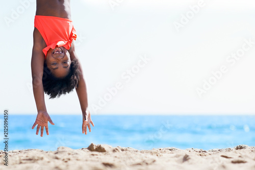Obraz na plátne Hanging, smile and portrait of black child at beach for summer vacation, freedom and travel