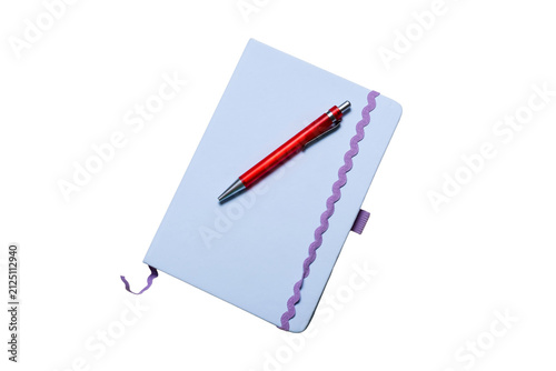 Close-up angled perspective of a light purple journal with a red pen resting on its cover