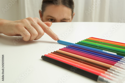 Obraz na plátně Woman Carefully Arranging Colorful Markers in Perfect Order, Perfectionism and O