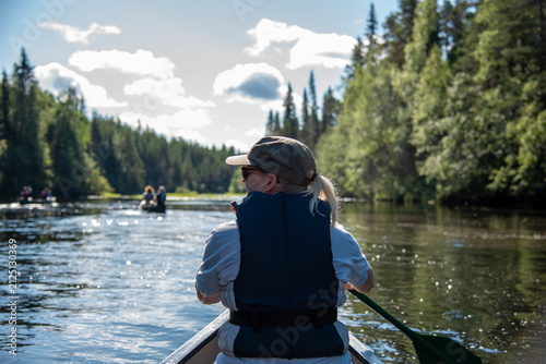 Woman canoeing in Lapland Finland
