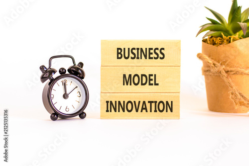 Business model innovation words symbol. Concept words Business model innovation on beautiful wooden blocks. Beautiful white background. Black alarm clock. Business model innovation concept Copy space