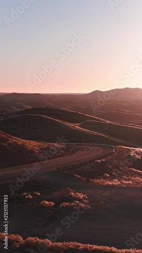 Dirt track through desert hills, Namibia. Aerial drone view of a winding road crossing the Sossusvlei highlands.