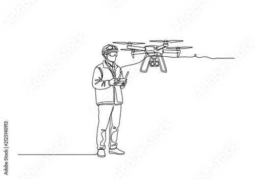 Drone operator controlling unmanned aerial vehicle in field
