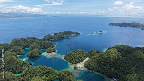 Bild auf Leinwand Aerial view of Sohoton Caves Natural Bridge Park featuring lush green limestone islands surrounded by turquoise and deep blue waters in Basey, Eastern Visayas, Philippines
